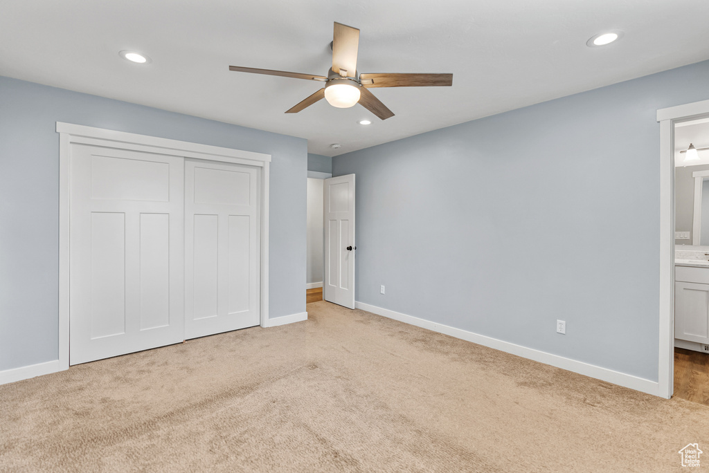 Unfurnished bedroom featuring connected bathroom, recessed lighting, baseboards, and carpet floors