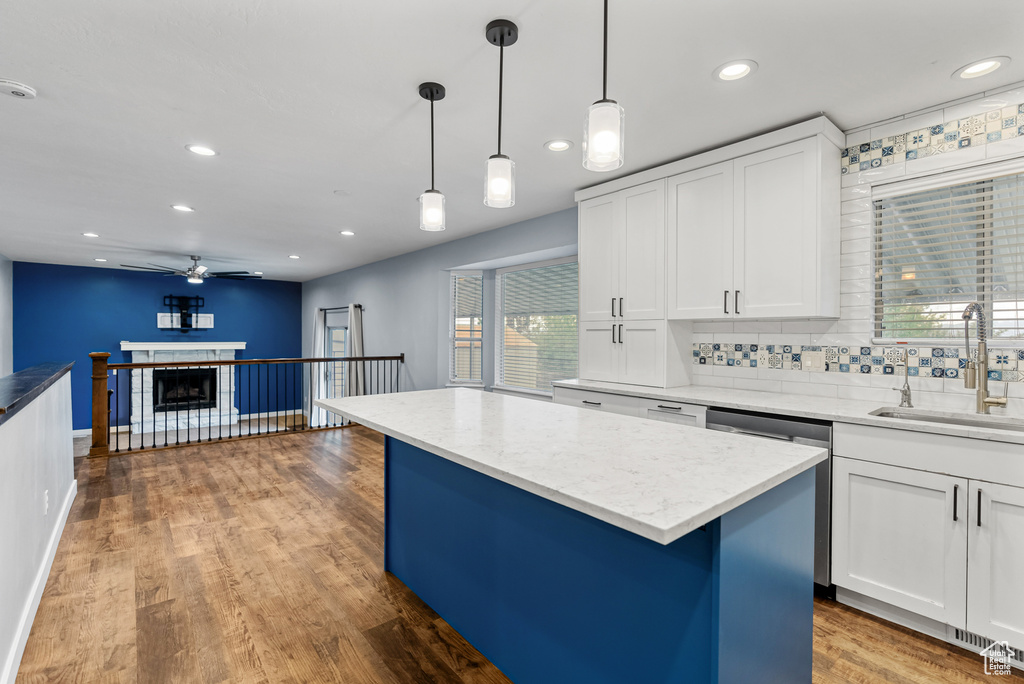 Kitchen with white cabinetry, a ceiling fan, recessed lighting, and a sink