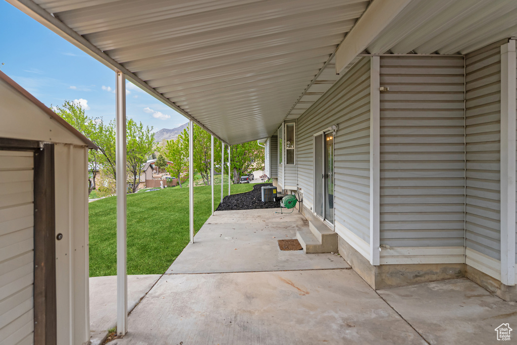 View of patio with central AC and a mountain view