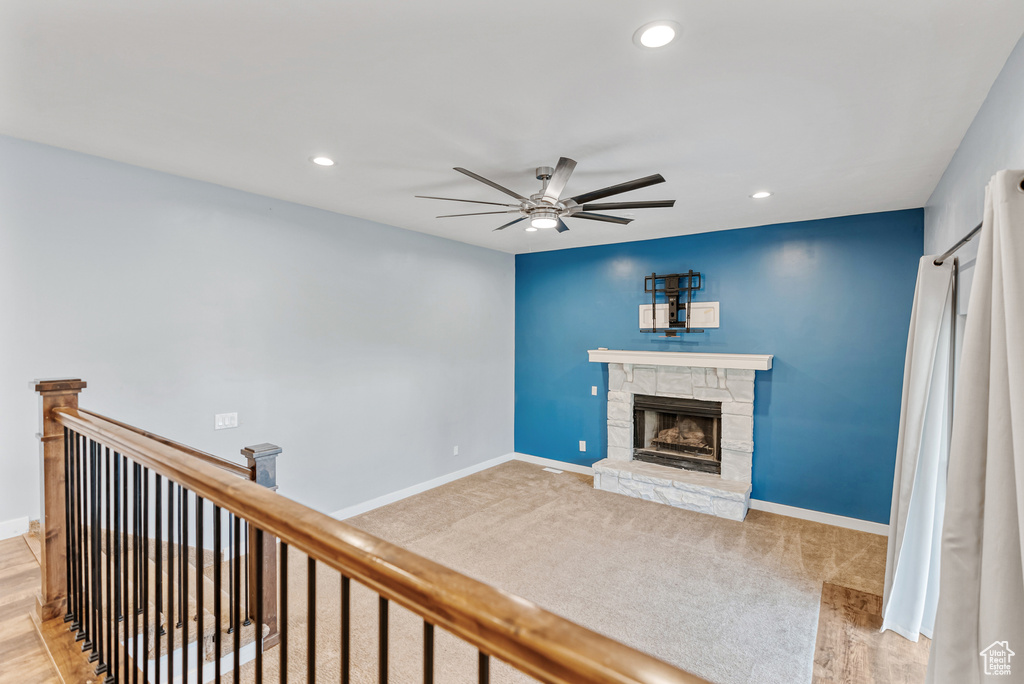 Living area featuring baseboards, recessed lighting, a ceiling fan, and a fireplace