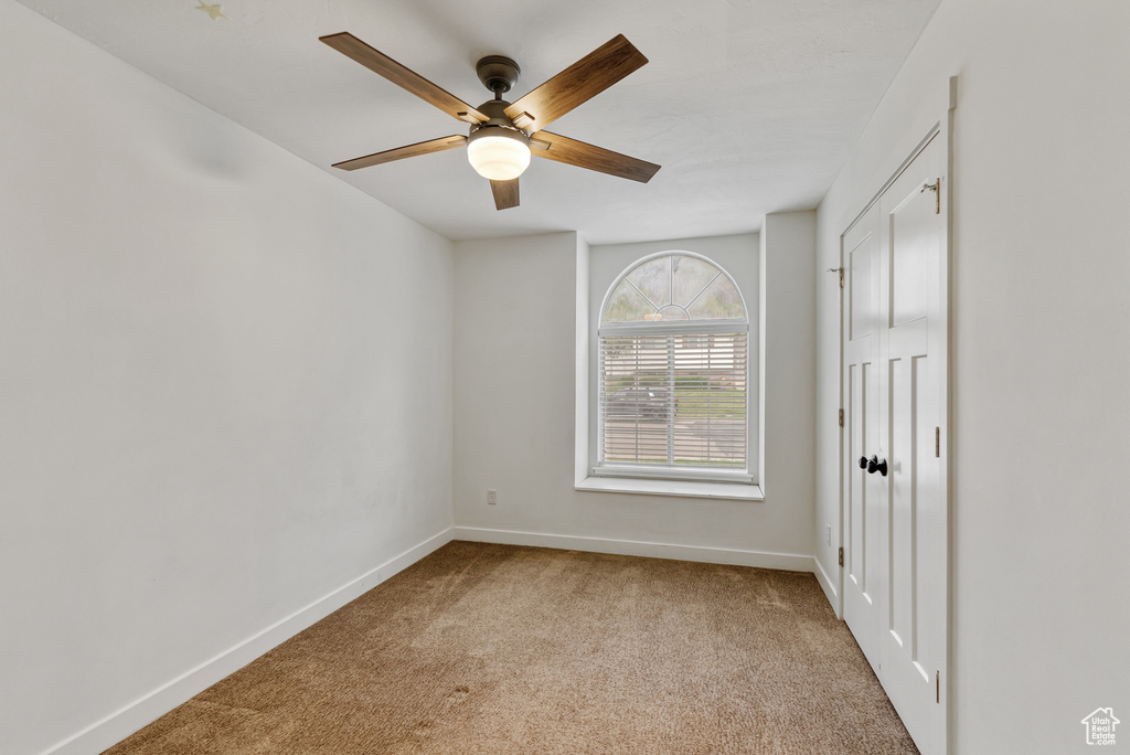 Unfurnished bedroom featuring a ceiling fan, a closet, carpet floors, and baseboards