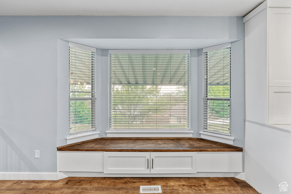 Interior details with baseboards, visible vents, and wood finished floors