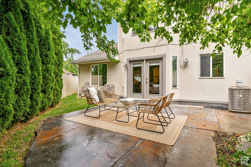 View of patio / terrace with french doors, fence, and central air condition unit