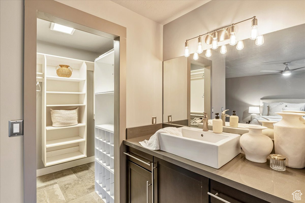 Bathroom with ceiling fan and vanity