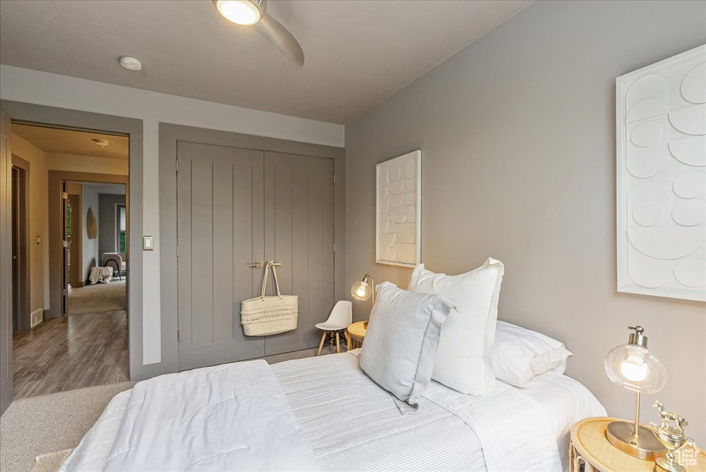 Bedroom featuring wood finished floors and a closet