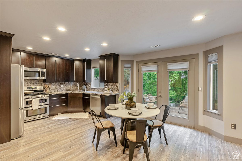 Dining area featuring french doors, plenty of natural light, light wood-type flooring, and recessed lighting