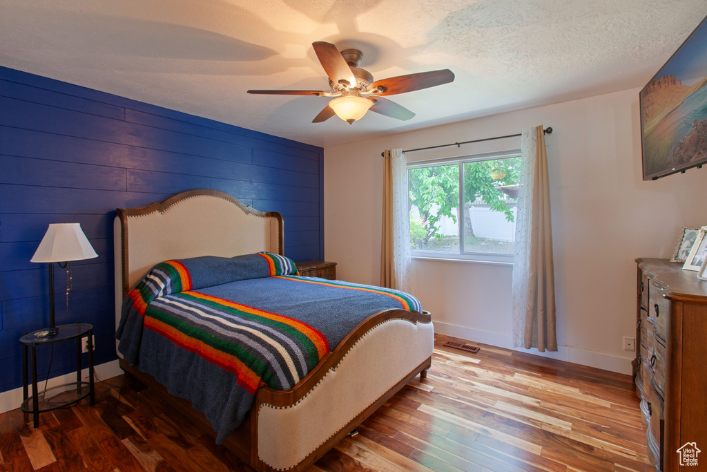 Bedroom featuring wood finished floors, ceiling fan, and baseboards
