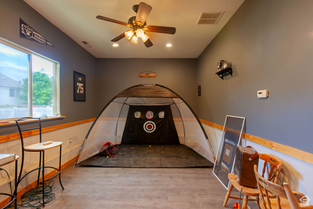 Rec room with wood finished floors, a ceiling fan, recessed lighting, and baseboards