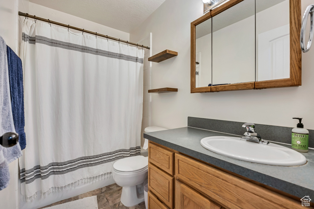 Full bathroom featuring toilet and vanity