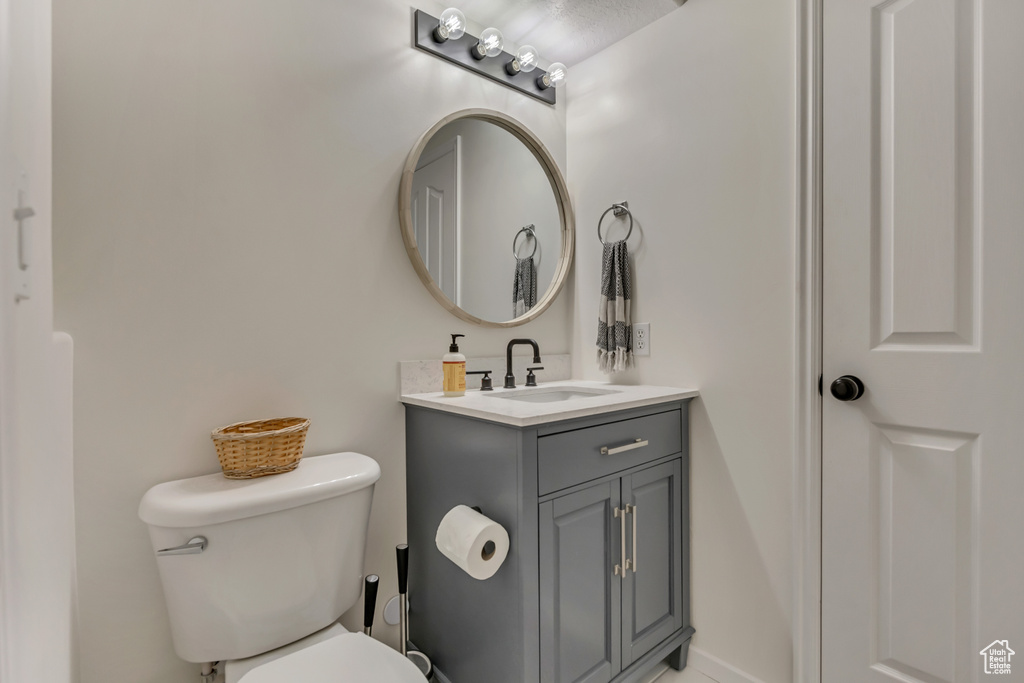 Half bathroom with toilet and vanity