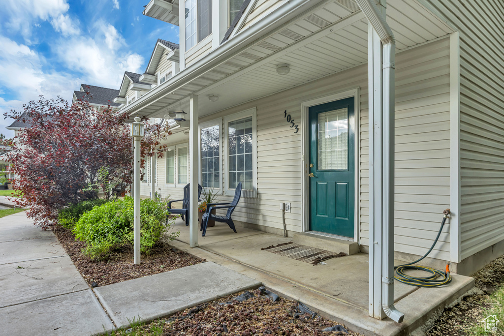 View of exterior entry with covered porch