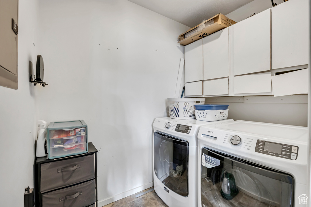 Clothes washing area with cabinet space and washer and clothes dryer