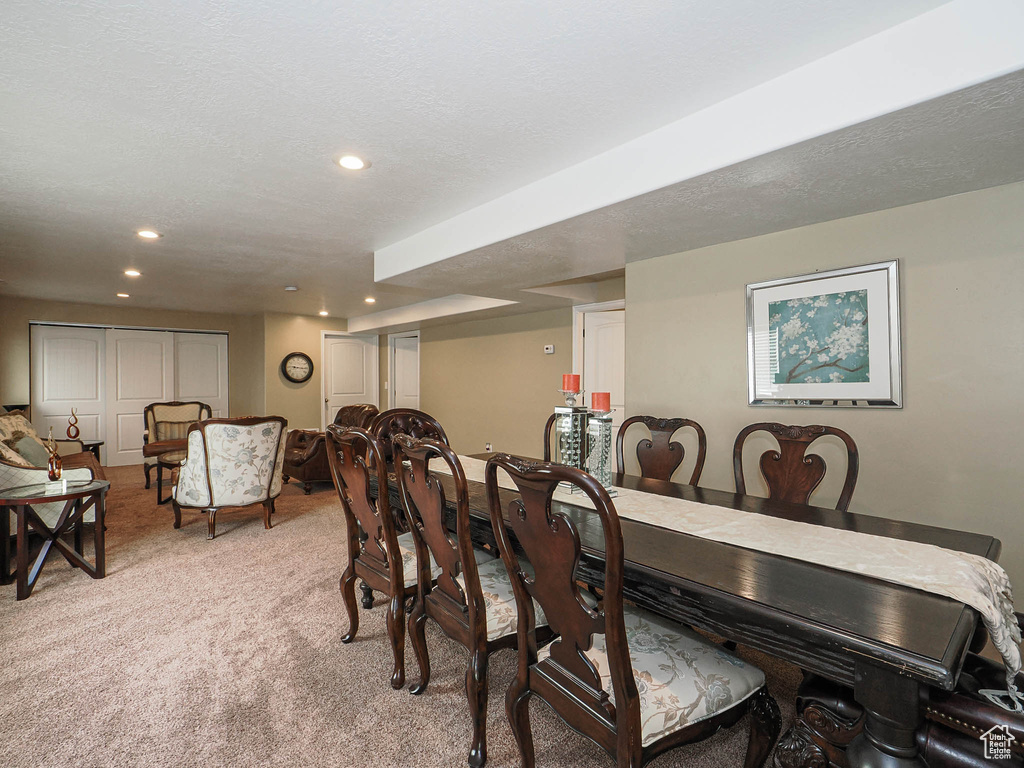 Dining room with light carpet and recessed lighting