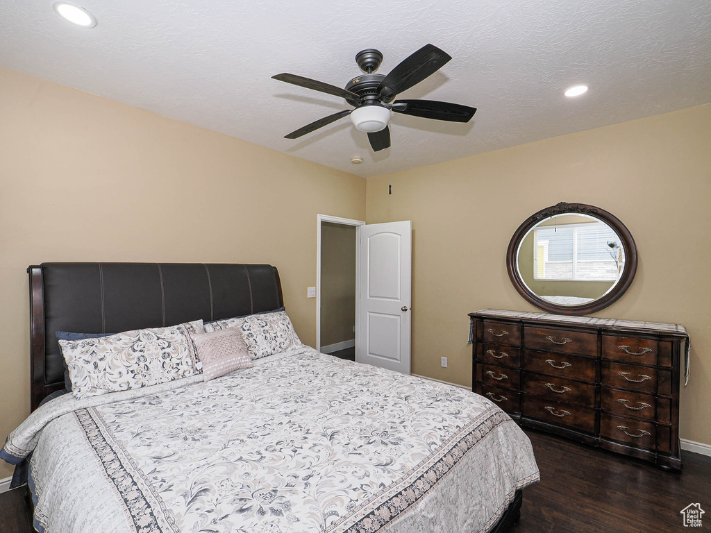 Bedroom featuring dark wood finished floors, baseboards, recessed lighting, and a ceiling fan