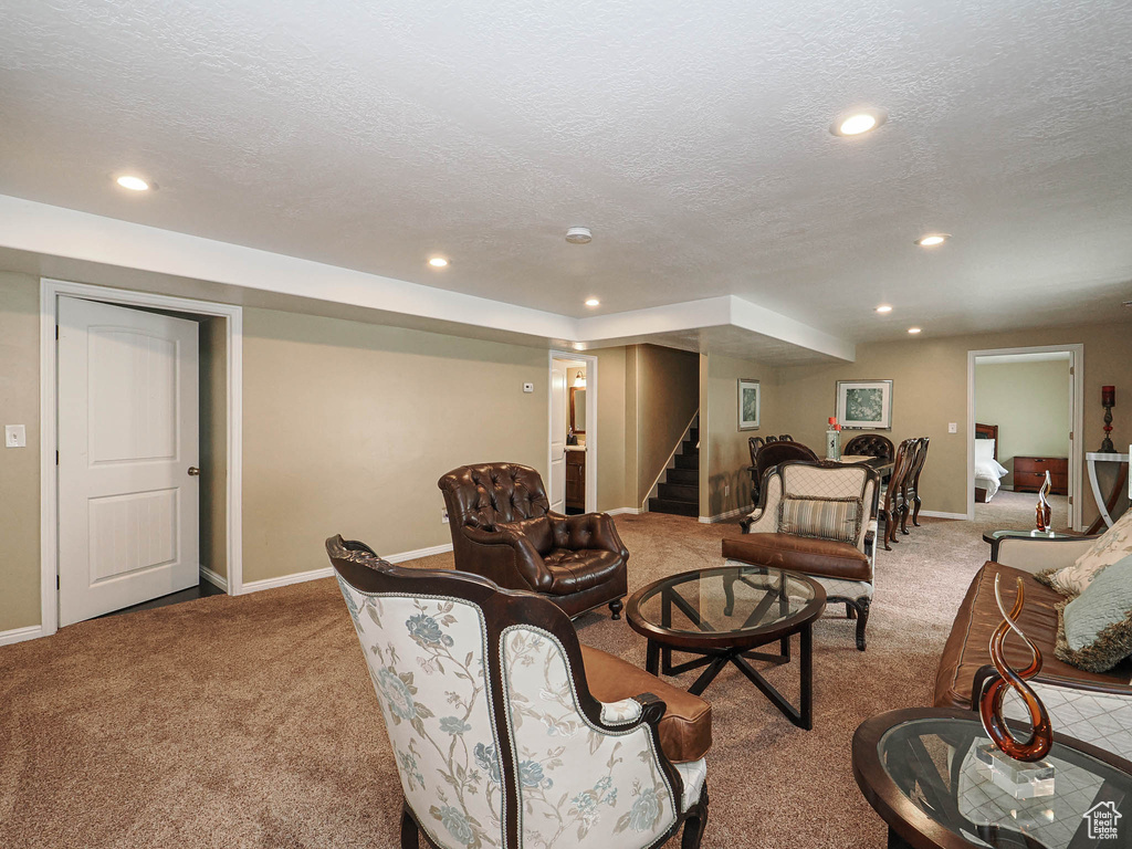 Carpeted living room with baseboards, recessed lighting, stairs, and a textured ceiling
