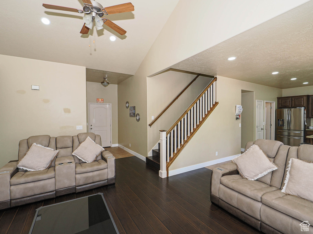 Living room featuring stairs, baseboards, a ceiling fan, dark wood-style flooring, and recessed lighting