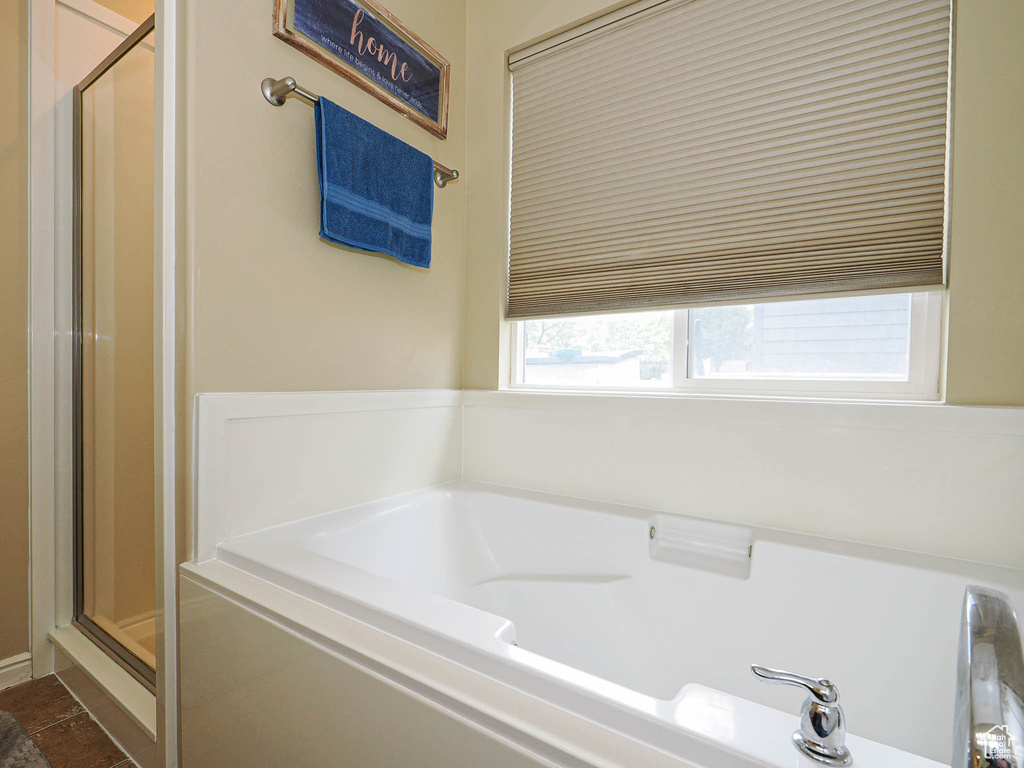 Bathroom with a shower stall and a garden tub