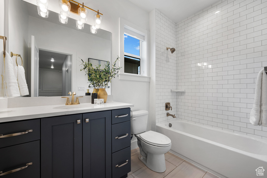 Full bath with toilet, vanity, and bathing tub / shower combination