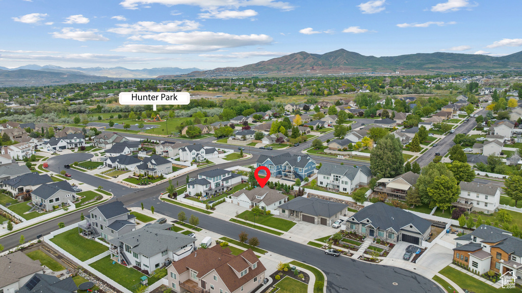 Aerial perspective of suburban area featuring a mountain backdrop