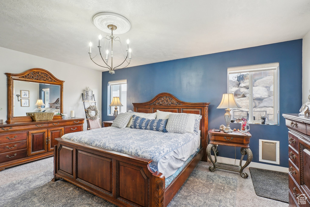 Bedroom featuring carpet floors and a chandelier