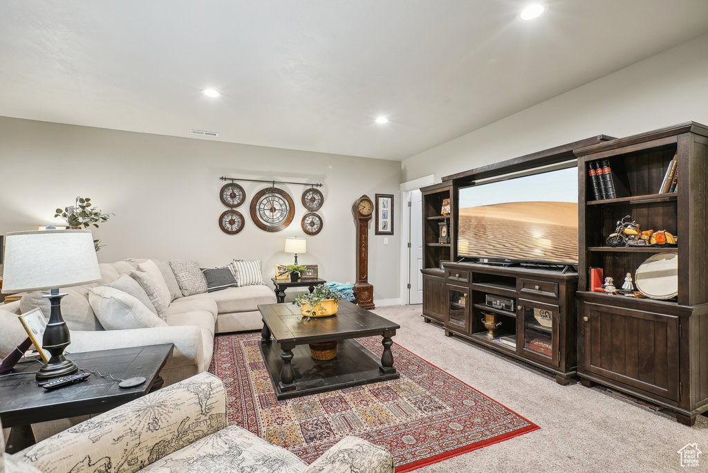 Living room featuring light colored carpet, recessed lighting, and baseboards