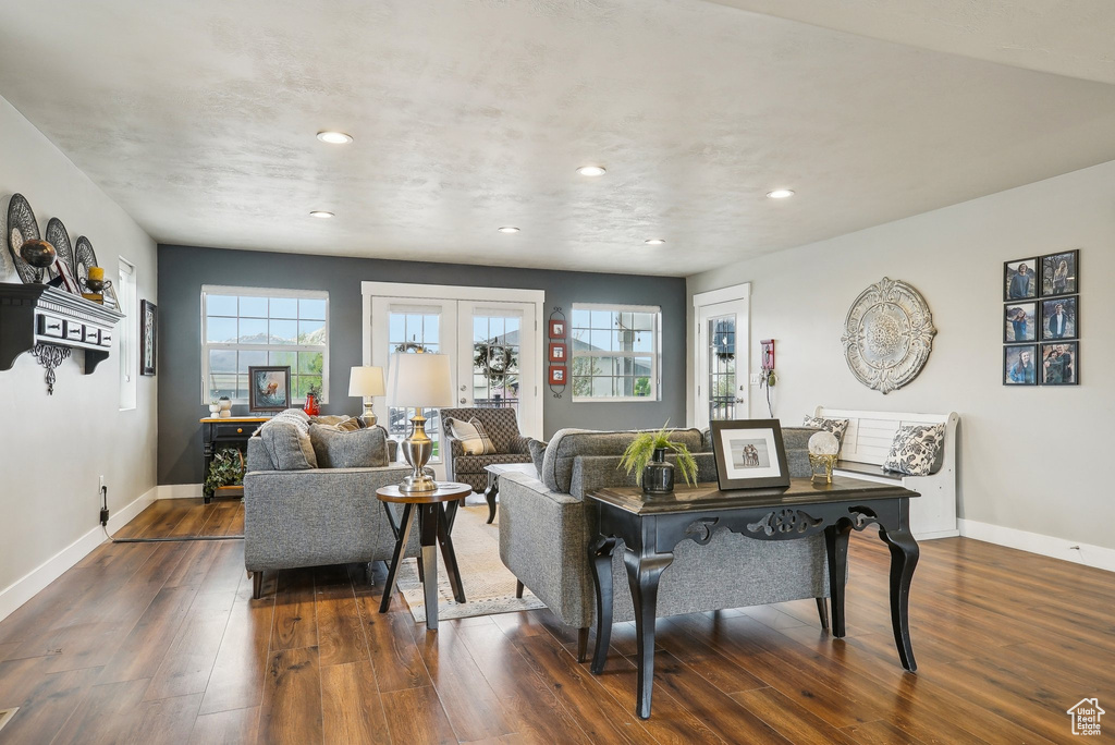 Living area featuring dark wood finished floors, baseboards, recessed lighting, and french doors