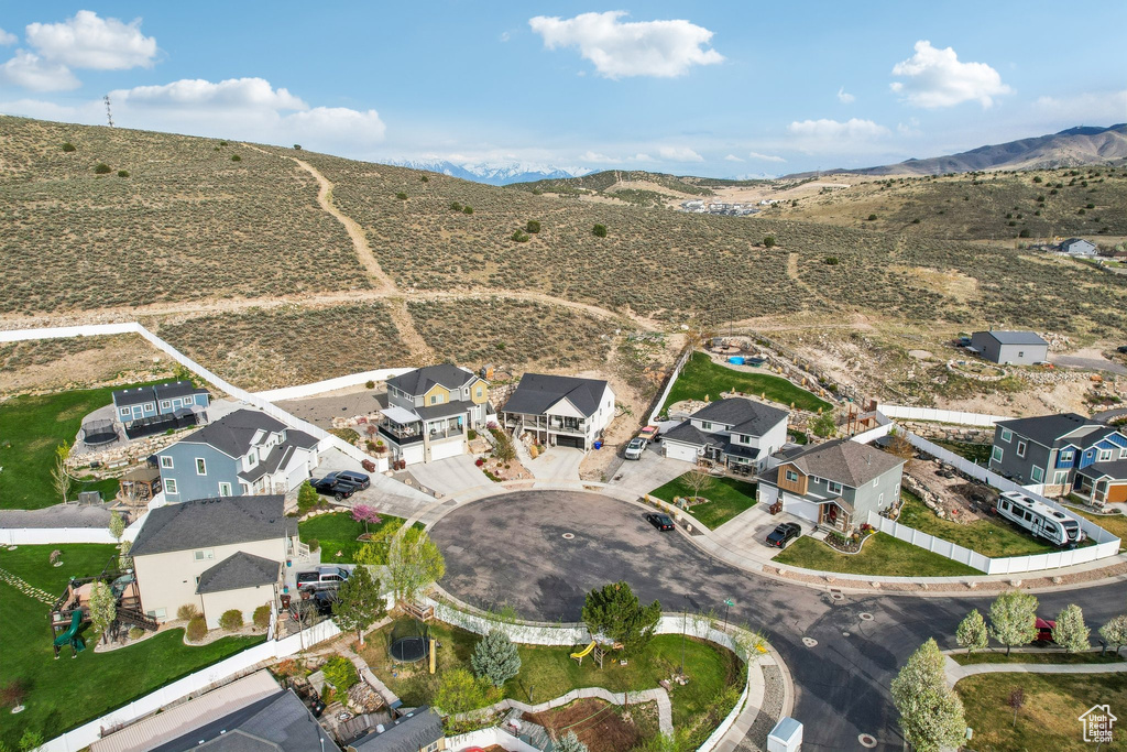 Aerial overview of property\'s location with mountains and nearby suburban area
