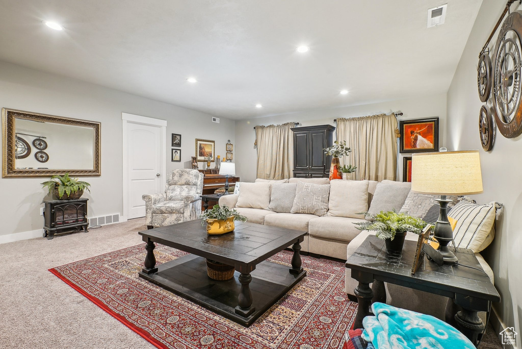 Carpeted living area featuring recessed lighting and baseboards