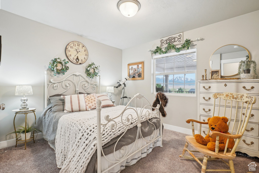 Bedroom featuring carpet floors and baseboards