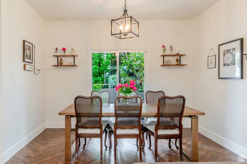 Dining space featuring a chandelier and baseboards
