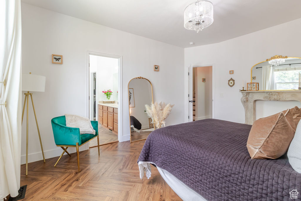 Bedroom featuring a chandelier and baseboards