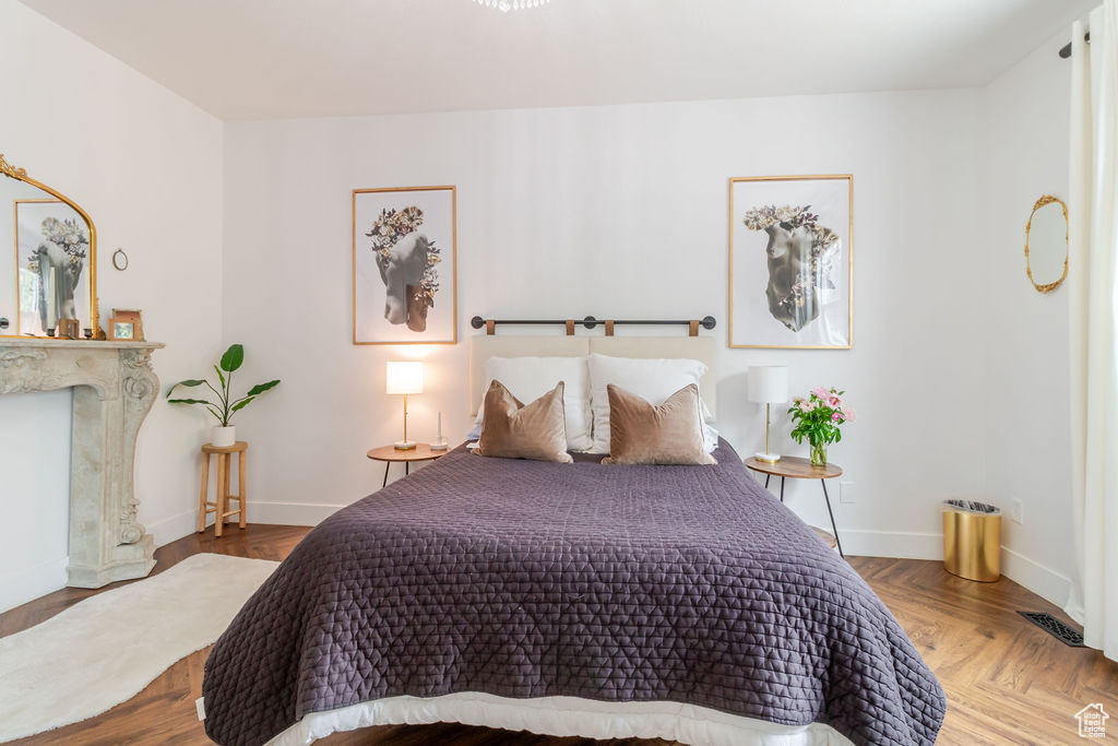 Bedroom with baseboards and a high end fireplace