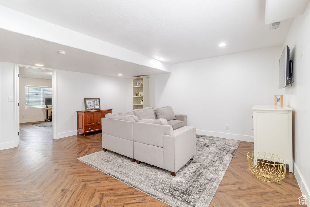 Living area featuring baseboards and recessed lighting