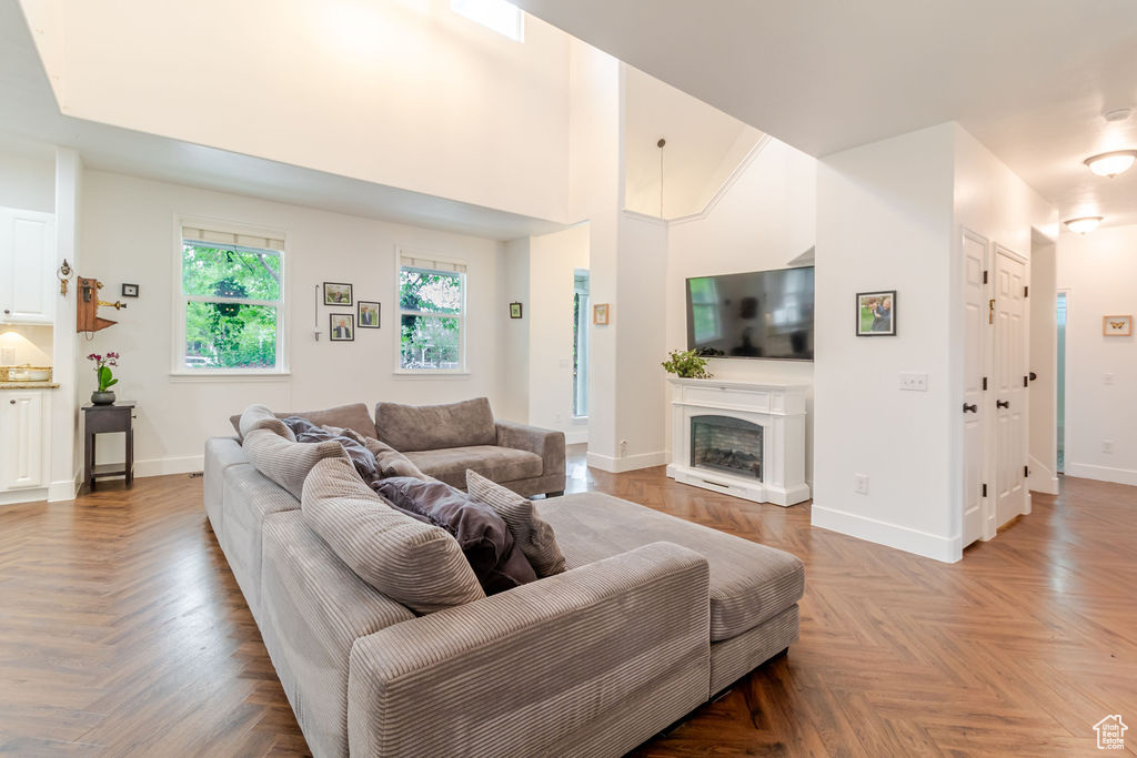 Living area with a fireplace with raised hearth and baseboards