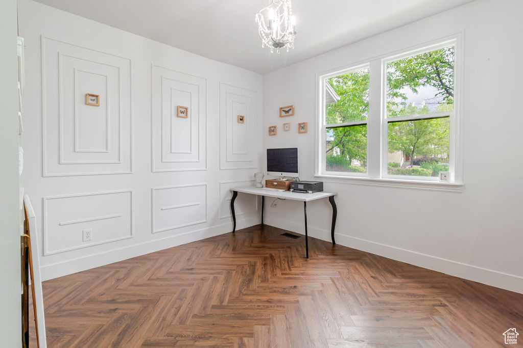 Office space featuring baseboards and a chandelier