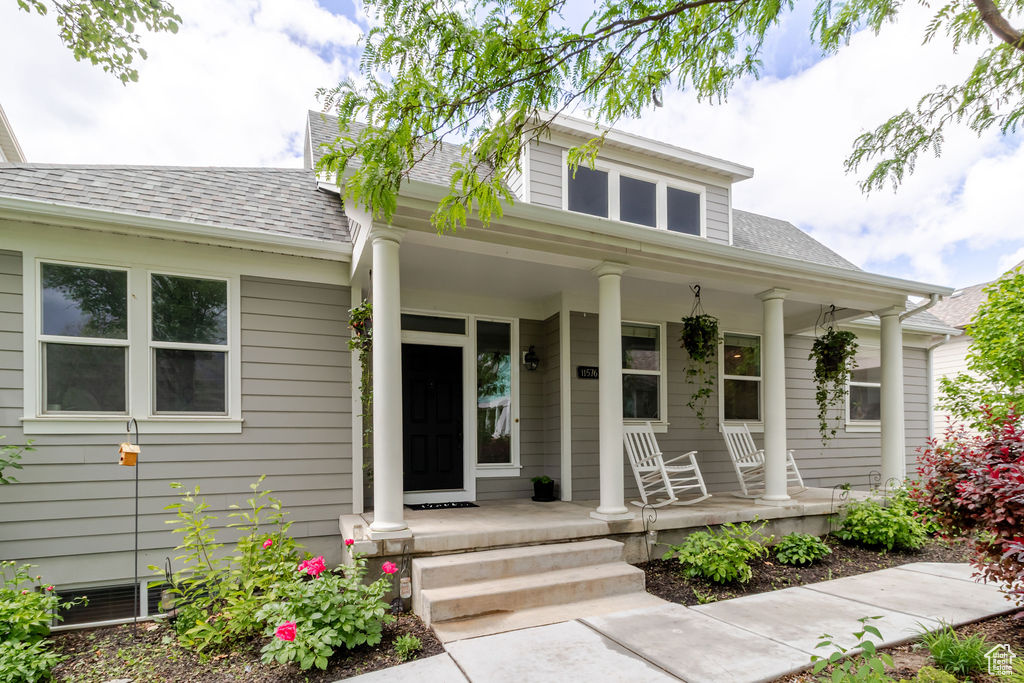 Bungalow-style house with covered porch and roof with shingles