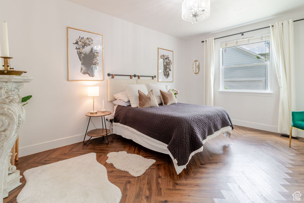 Bedroom featuring baseboards and a chandelier