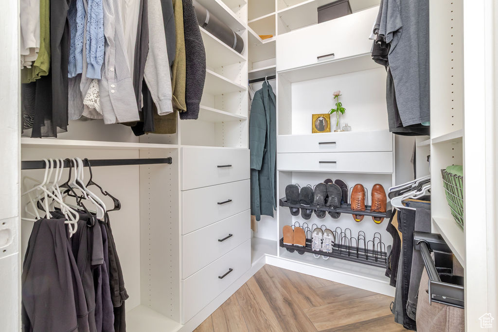 Walk in closet featuring parquet floors