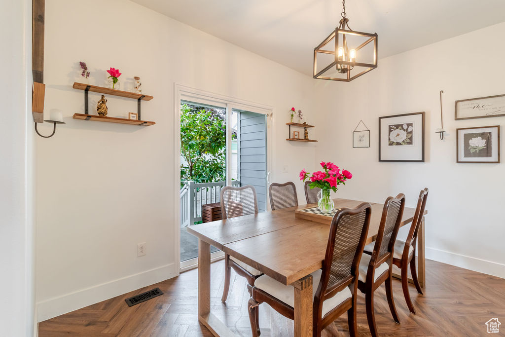 Dining area featuring a chandelier and baseboards
