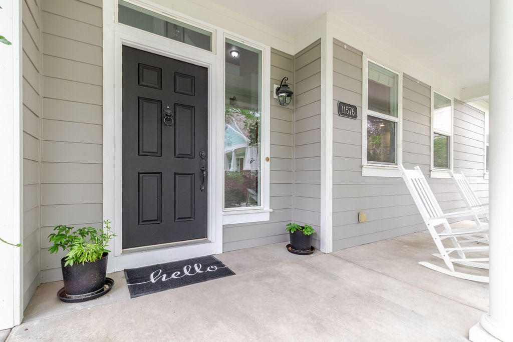 Entrance to property featuring covered porch
