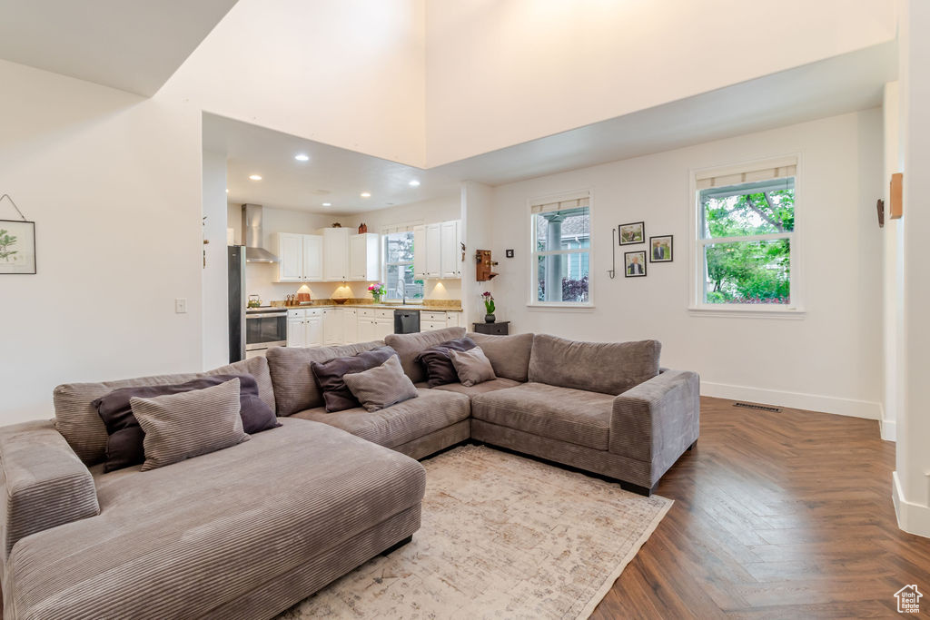 Living room with healthy amount of natural light, baseboards, and recessed lighting