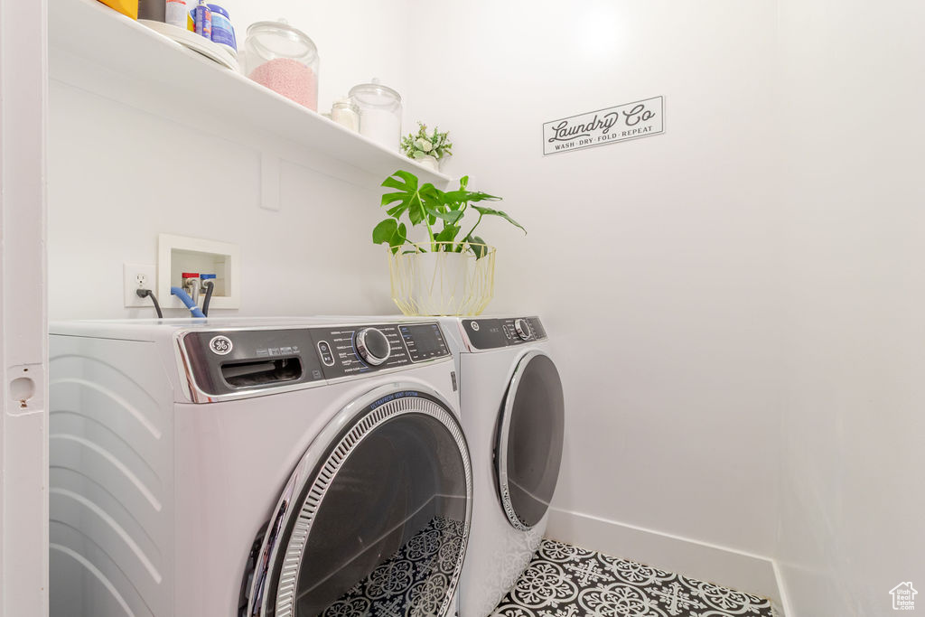 Washroom featuring independent washer and dryer, baseboards, and tile patterned floors