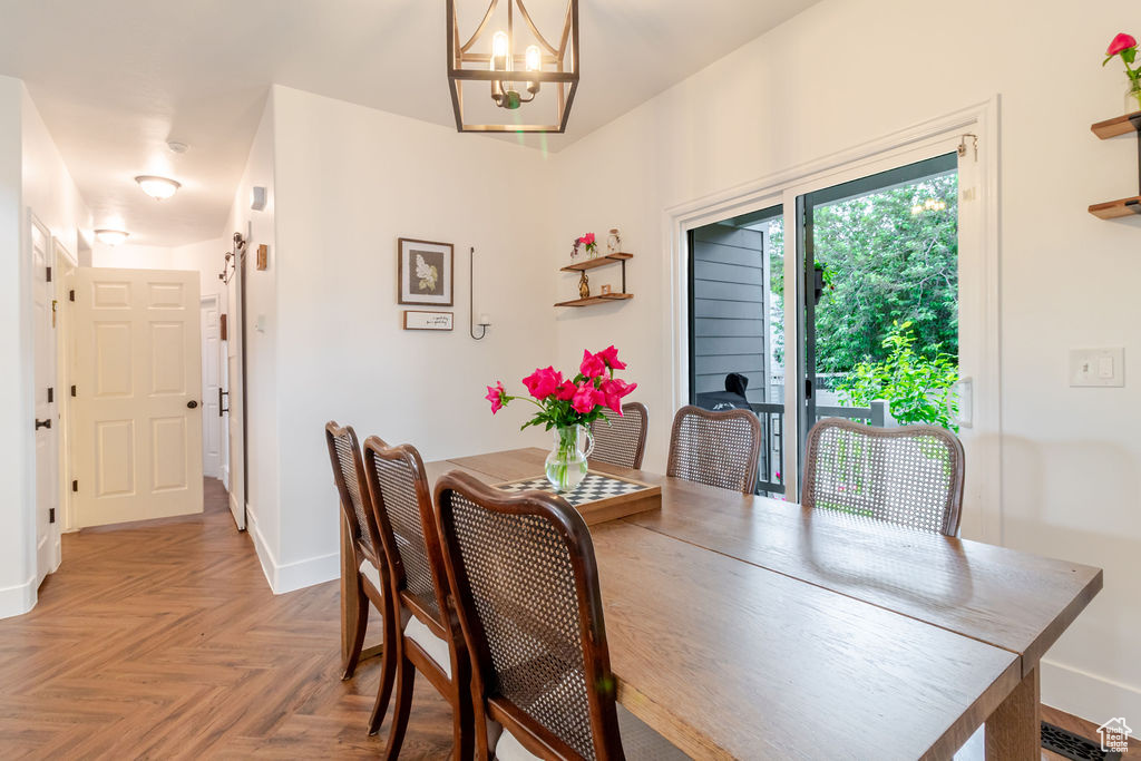 Dining area with a chandelier and baseboards