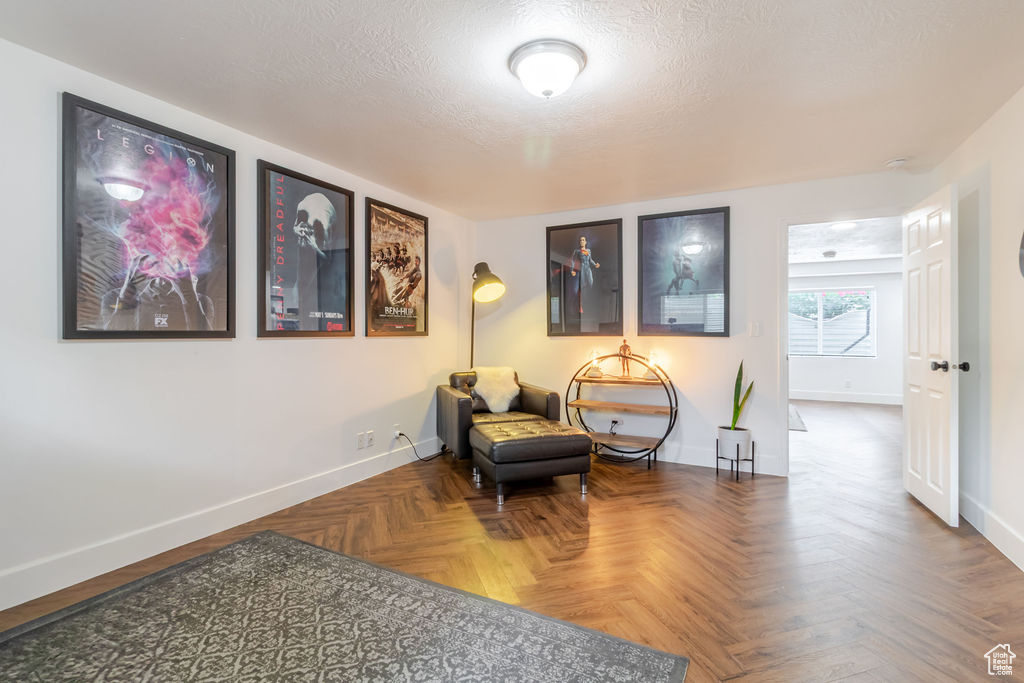 Sitting room with baseboards and a textured ceiling