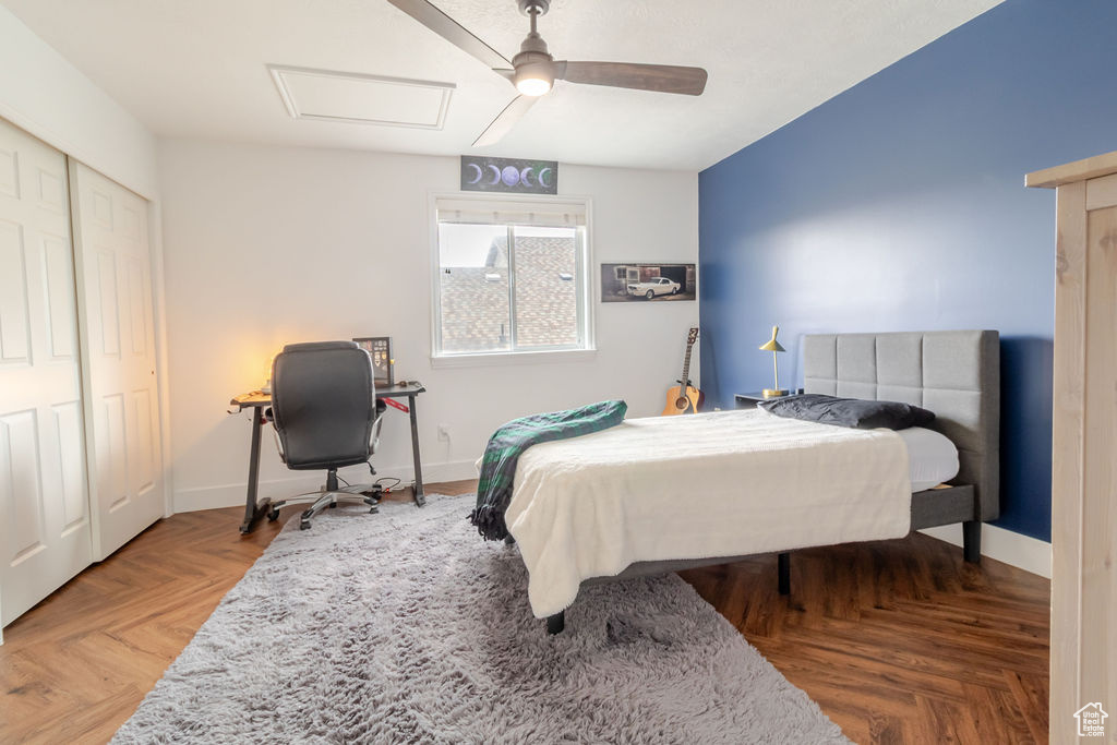 Bedroom with attic access, a ceiling fan, baseboards, and a closet