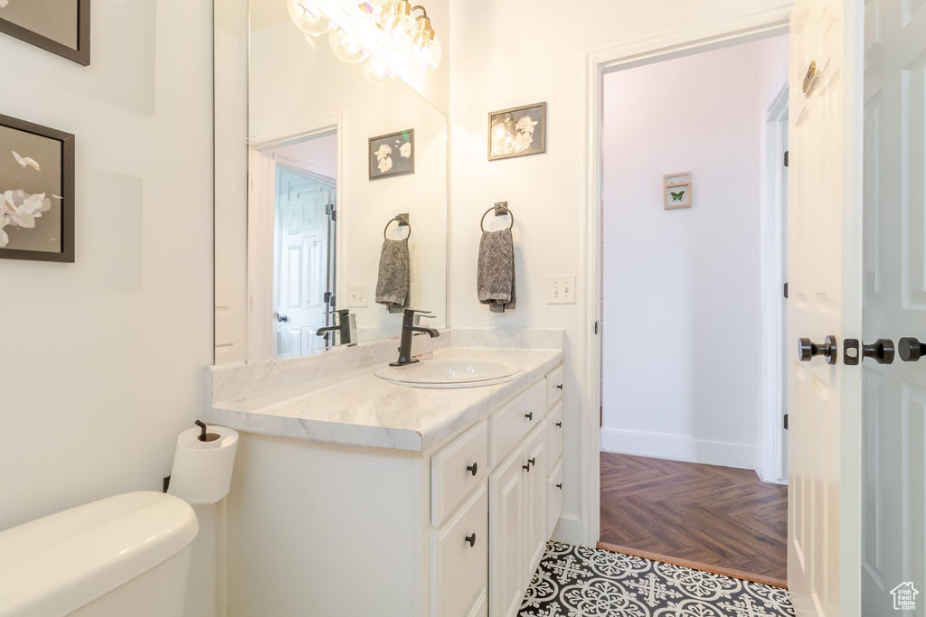 Half bathroom featuring toilet and vanity