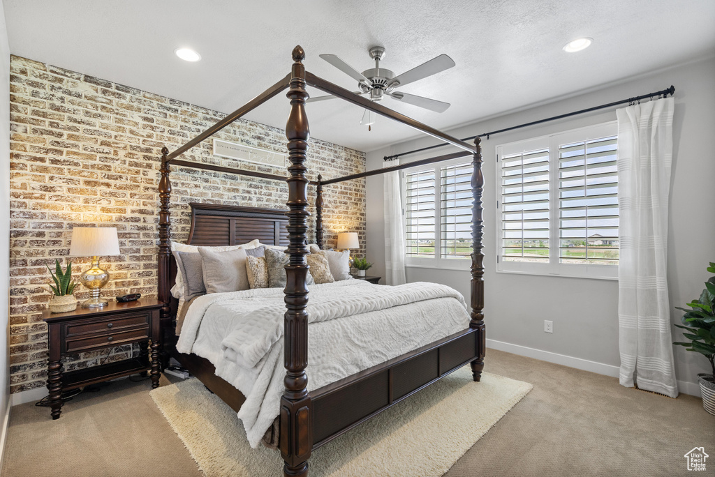 Bedroom featuring brick wall, carpet floors, baseboards, recessed lighting, and a ceiling fan