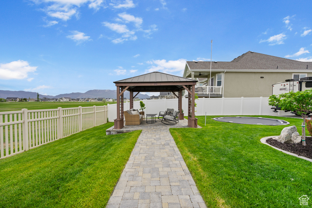 View of yard with a gazebo, a patio, a mountain view, and an outdoor hangout area