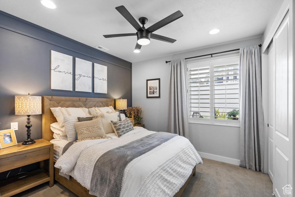 Carpeted bedroom with a closet, baseboards, recessed lighting, and a ceiling fan