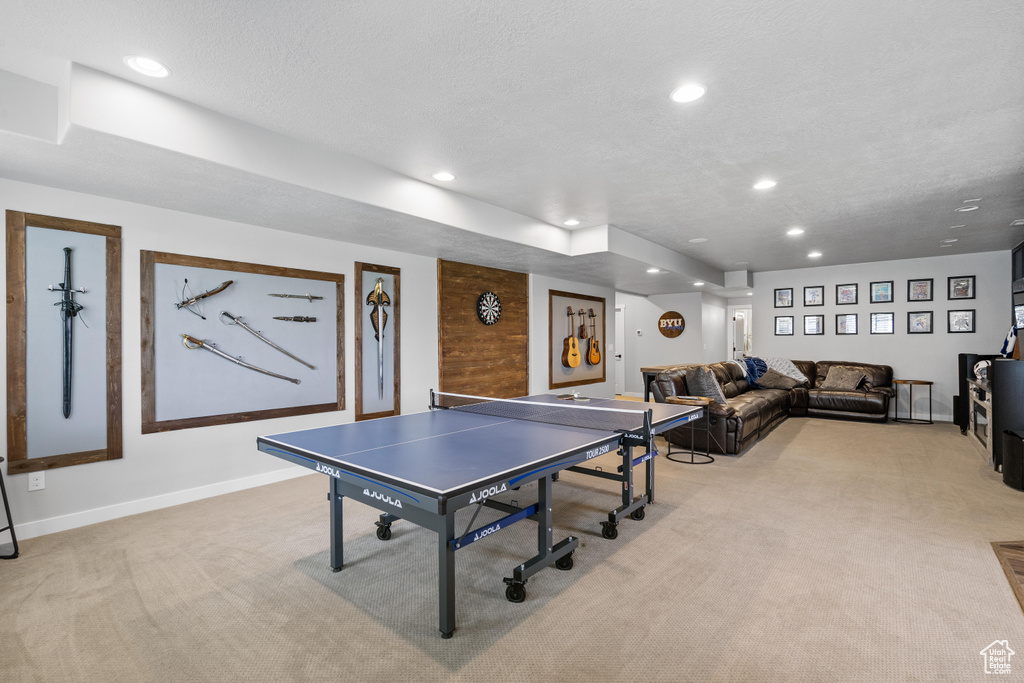 Rec room with light carpet, recessed lighting, baseboards, and a textured ceiling